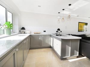 a kitchen with stainless steel cabinets and a large island at Upper Oaks in Windermere