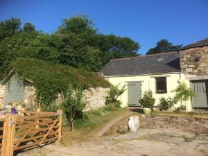 una casa blanca con una puerta y una valla en The Coach House, en Bodmin