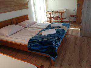 a bedroom with a bed with two pillows on it at Guest House Kovalik in Suchá Hora