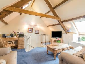 a living room with a couch and a table at Jenny's Cottage in Alnwick