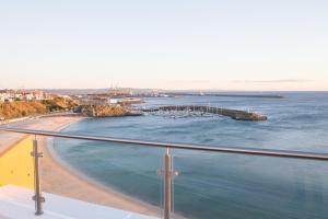 a view of a beach and the ocean at Hotel Veleiro in Sines