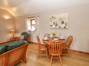 a living room with a table and chairs and a couch at The Hayloft in Alston