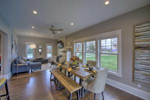 a dining room and living room with a table and chairs at Renovated Craftsman House with Patio and Fire Pit! in Vevay