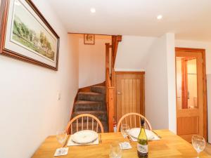 a dining room with a wooden table with wine glasses at The Hayloft in Brampton