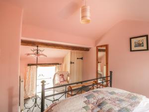 a bedroom with a bed and a mirror at Honey Bee Cottage in Scarborough