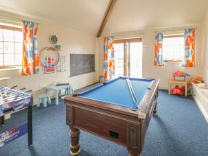 a childrens play room with a pool table at Lily Cottage in Caernarfon