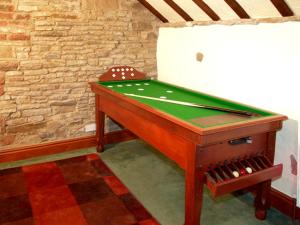 a pool table in a room with a pool cue at The Loft in Dronfield