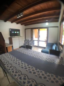 una camera da letto con un letto e un soggiorno di Linda casa com piscina em Bombinhas, espaço inteiro a Bombinhas Altre 29 foto