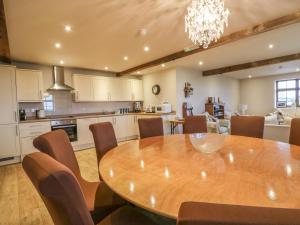 Il comprend une cuisine et une salle à manger avec une table et des chaises en bois. dans l'établissement Hop House, à Sittingbourne