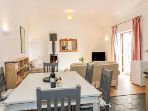 a living room and dining room with a table and chairs at Hen Stabl in Beaumaris