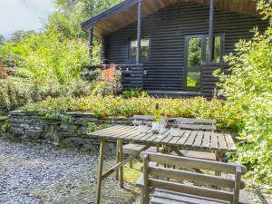 a picnic table in front of a log cabin at Buttermere in Ulverston