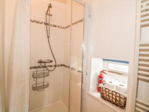 a shower with a glass door in a bathroom at The Studio in Bradwell