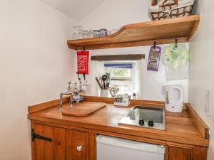 a kitchen with a sink and a counter top at The Studio in Bradwell