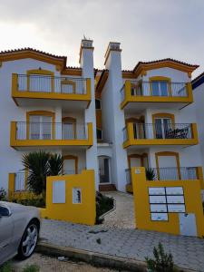 a building with a car parked in front of it at Cozy apartment in Algarve West Coast - Aljezur (2 min da Praia Monte Clérigo) in Aljezur