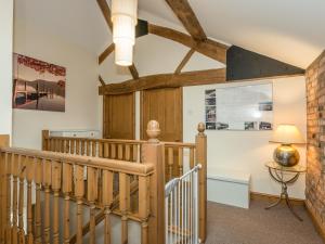 a staircase in a house with wooden beams at The Coach House in Oswestry