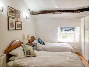 Säng eller sängar i ett rum på Farrier's Cottage
