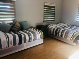 A bed or beds in a room at Elmcroft Guest House 