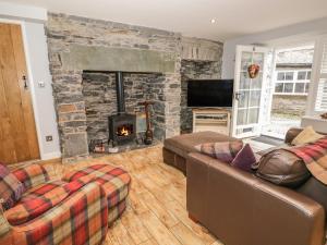 a living room with a couch and a fireplace at The Old Laundry in Ambleside