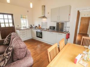 a kitchen with a couch and a table in a room at Beacon in Saltburn-by-the-Sea