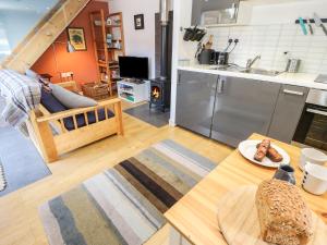 a kitchen and a living room with a table at The Sidings in Matlock