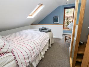 a bedroom with a bed and a window at The Sidings in Matlock