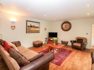 a living room with a couch and a table at The Old Stables in Chesterfield