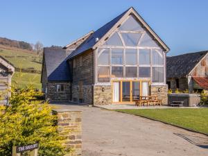 a barn conversion with a large glass extension to a house at The Hayloft in Knighton