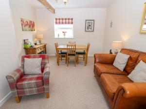 a living room with a couch and chairs and a table at The Byre in Ashbourne