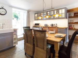 a kitchen with a wooden table and some chairs at The Dale Townhouse in Allendale Town