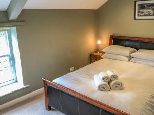 a bedroom with a bed with towels on it at The Granary in Appleton le Moors