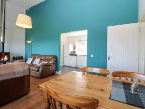 a living room with a table and chairs and a couch at Starfish Cottage in Craignure