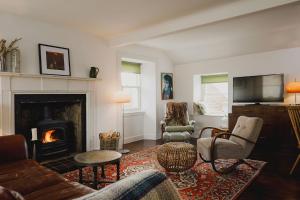 a living room with a couch and a fireplace at The Crow's Nest in Pittenweem