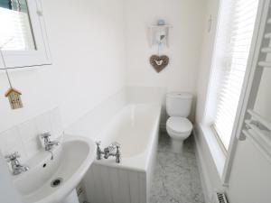 a white bathroom with a sink and a toilet at Croft View in Whitby