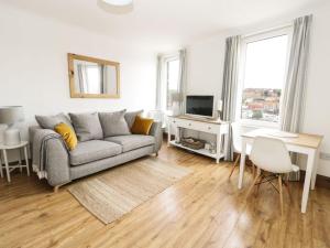 a living room with a couch and a tv at Marina View in Whitby