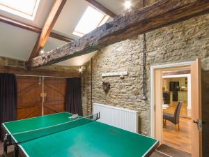 ヘクサムにあるGrove Cottageの石壁の部屋の卓球台