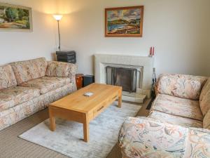 a living room with two couches and a coffee table at The Hide, Newtownards in Greyabbey