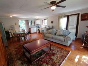 a living room with a couch and a table at Uvongo Log Home in Uvongo Beach