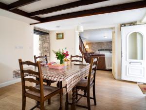 a dining room with a table and chairs at 3 Horse Pool Road in Laugharne