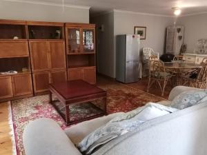 a living room with a couch and a table at Uvongo Log Home in Uvongo Beach