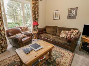 a living room with two couches and a coffee table at Rowan Cottage in Grasmere