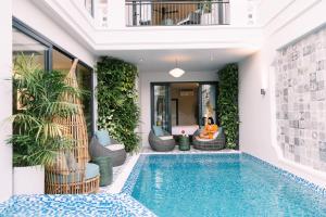 a swimming pool in a house with plants at Volar de Faifo Villa in Hoi An