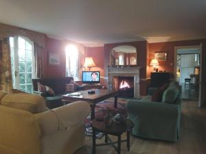 a living room with a couch and a fireplace at The Coach House in Lydford