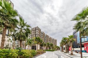 an image of a street with palm trees at Brand new 3 Bedroom apartment in Bluewaters island in Dubai