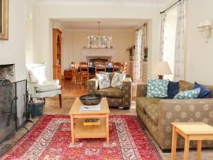 a living room with a couch and a table at Sandridge Barton in Stoke Gabriel