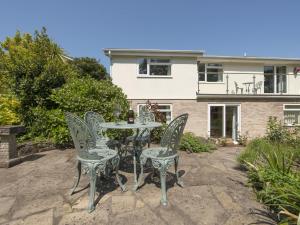 a table and chairs in front of a house at Exe View in Dawlish