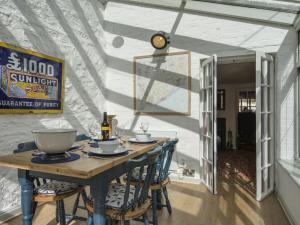 a dining room with a wooden table and chairs at 11 The Green in Budleigh Salterton +23 photos