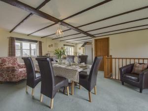 a dining room with a table and chairs at Owls Roost in Kentisbury