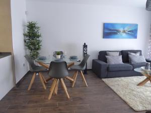 a living room with a table and a couch at NORASUITES32 in Las Lagunas