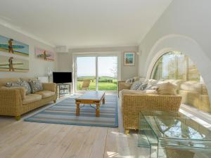 a living room with two couches and a table at Landcombe Cottage in Dartmouth