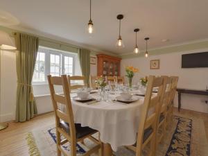 a dining room with a white table and chairs at Yellowland Farm in Merryfield